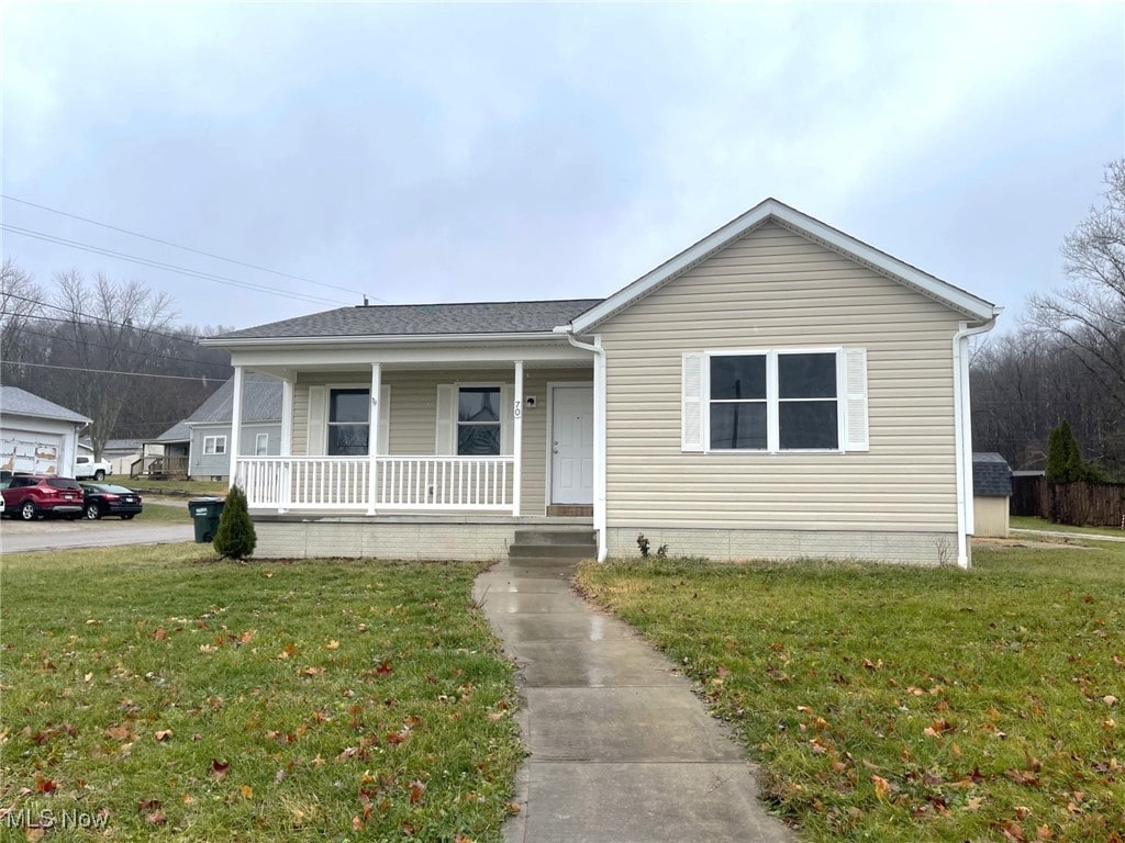 view of front of home with a front yard and covered porch