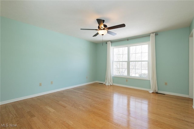 empty room with ceiling fan and light wood-type flooring