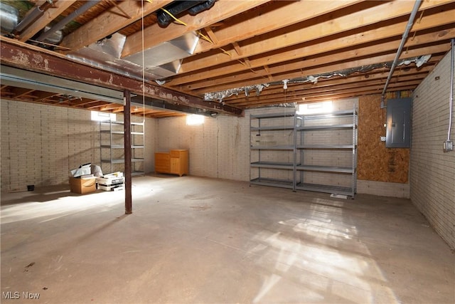 basement with brick wall and electric panel