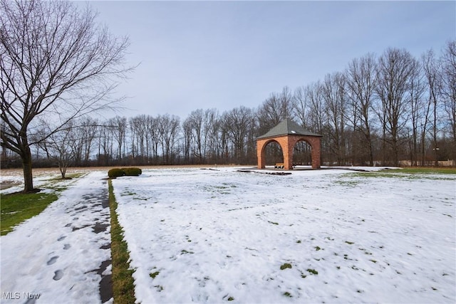 yard layered in snow featuring a gazebo