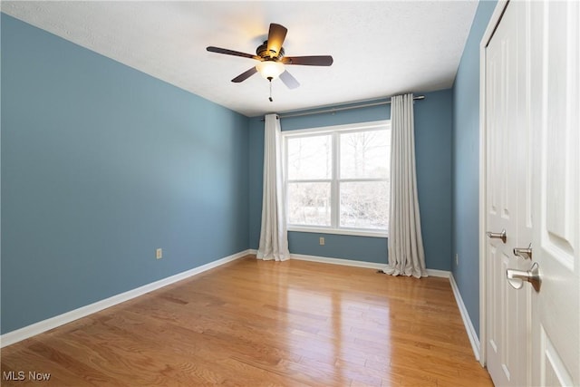 spare room featuring light hardwood / wood-style flooring and ceiling fan