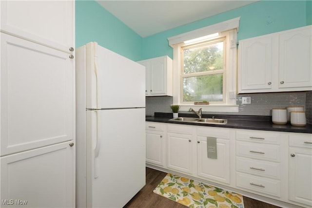 kitchen featuring decorative backsplash, white fridge, white cabinets, and sink