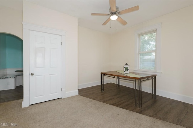 carpeted office featuring ceiling fan