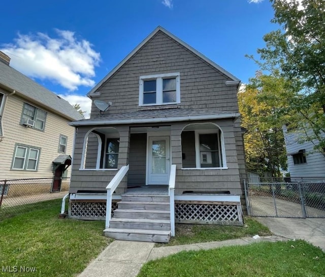 bungalow-style house with a front lawn