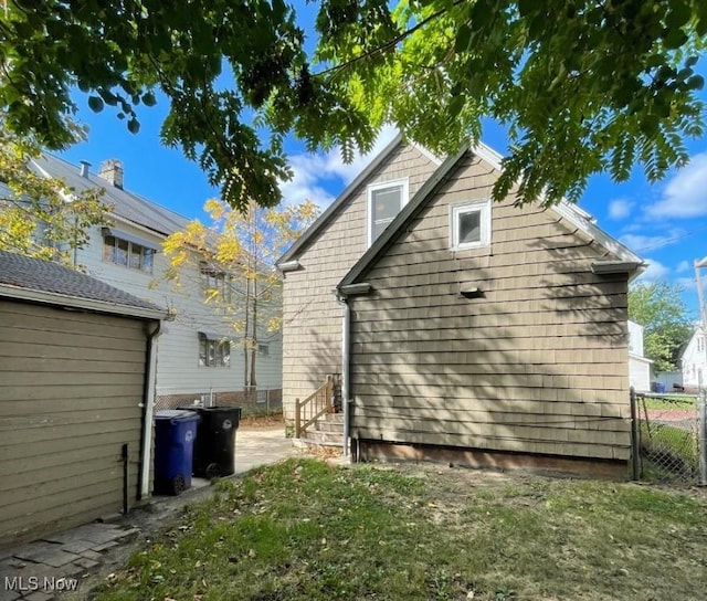 rear view of property featuring a yard