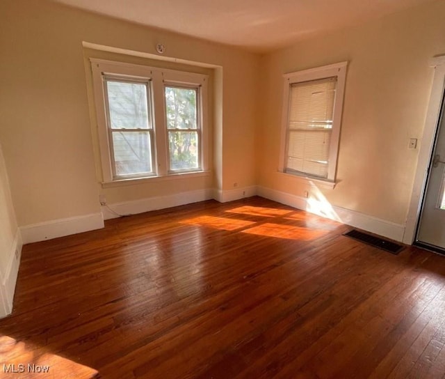 empty room with dark wood-type flooring