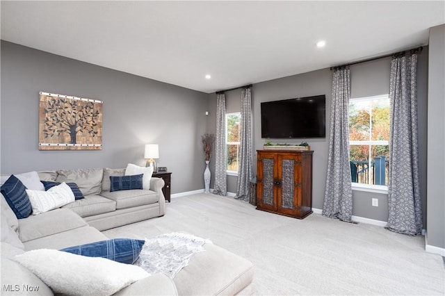 living room with carpet flooring and plenty of natural light