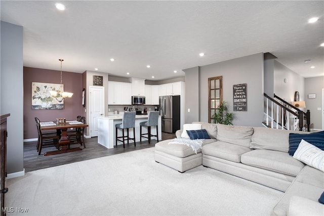 living room featuring a notable chandelier and dark hardwood / wood-style floors