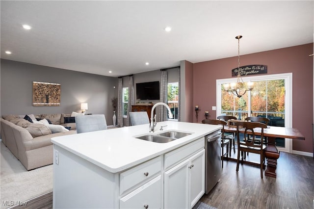 kitchen with sink, stainless steel dishwasher, an island with sink, decorative light fixtures, and white cabinets