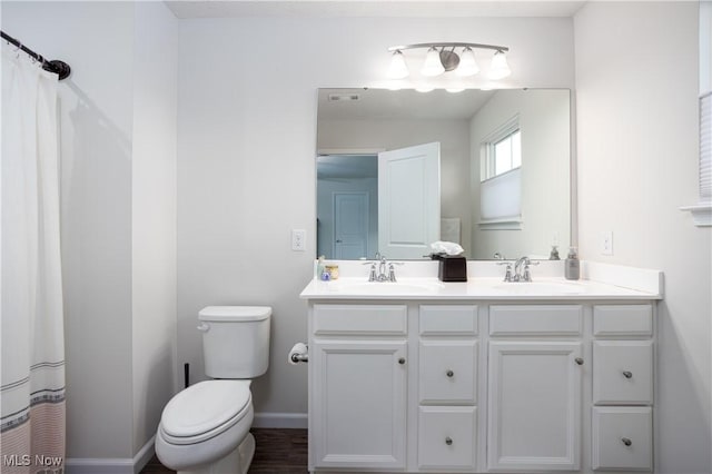 bathroom with a shower with shower curtain, vanity, and toilet