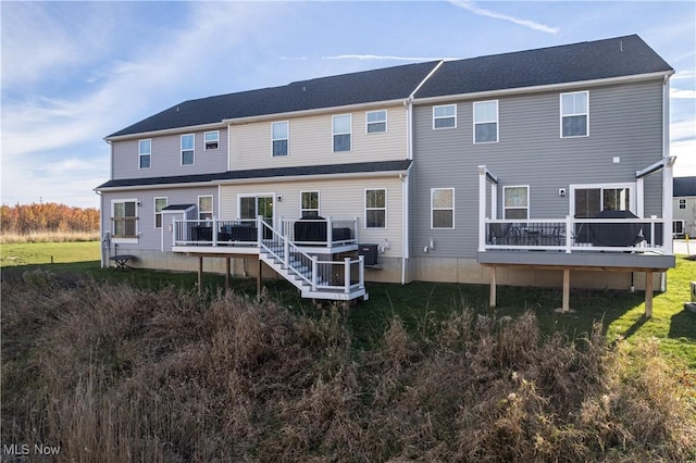 back of property with a wooden deck and central AC