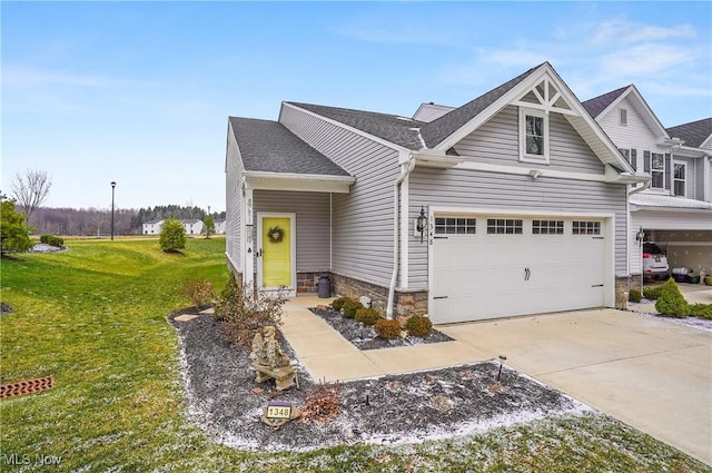 craftsman-style home featuring a front yard and a garage