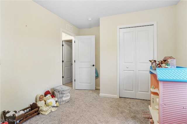 unfurnished bedroom with light carpet and a closet