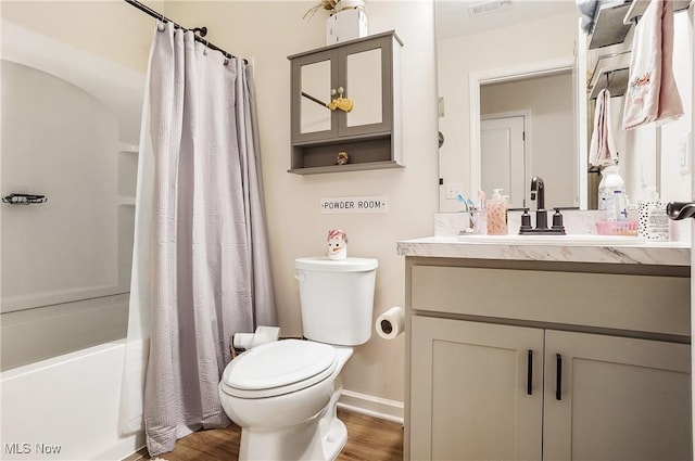 full bathroom featuring hardwood / wood-style floors, shower / bath combination with curtain, toilet, and vanity