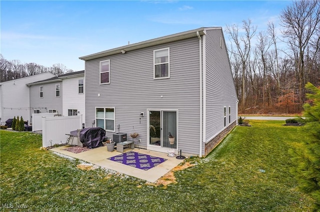 rear view of property featuring a yard and a patio area