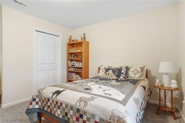 bedroom with carpet and a closet