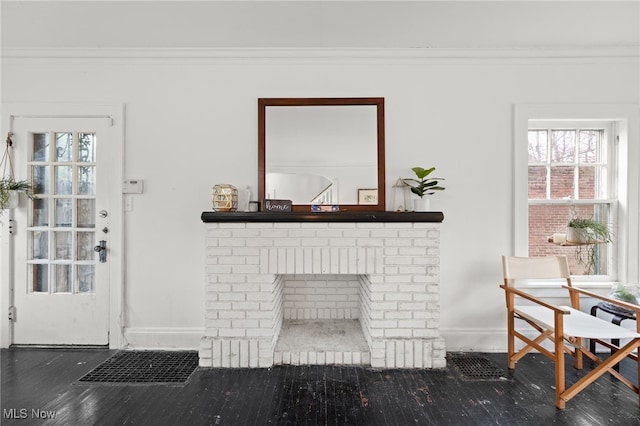 living room with crown molding and a fireplace