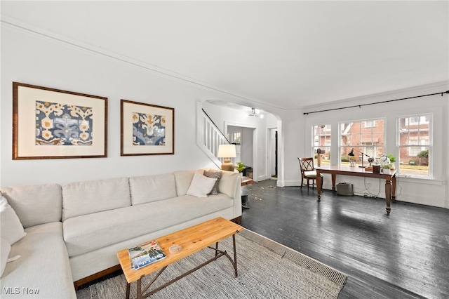 living room with dark hardwood / wood-style floors and crown molding