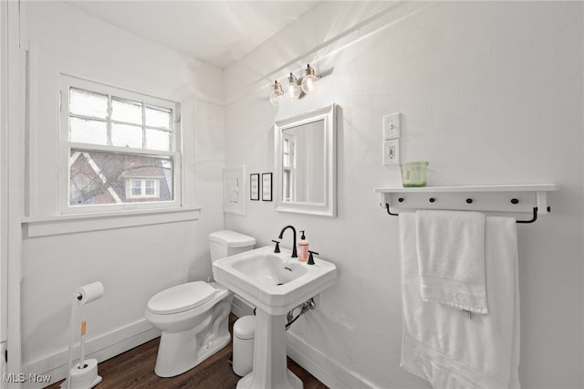 bathroom with toilet and wood-type flooring