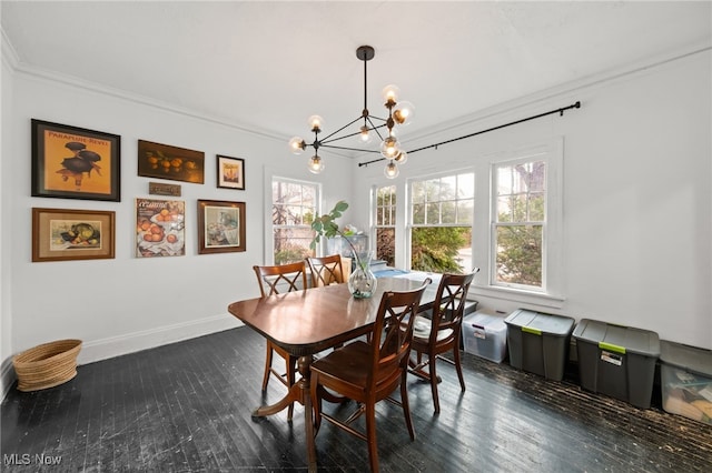 dining area featuring dark hardwood / wood-style floors, crown molding, and an inviting chandelier