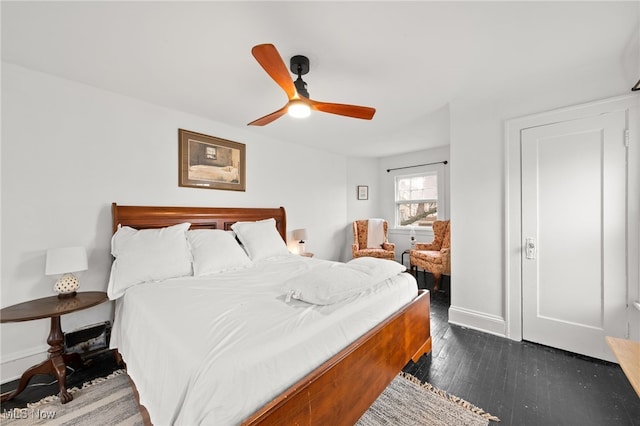 bedroom featuring ceiling fan and dark hardwood / wood-style floors