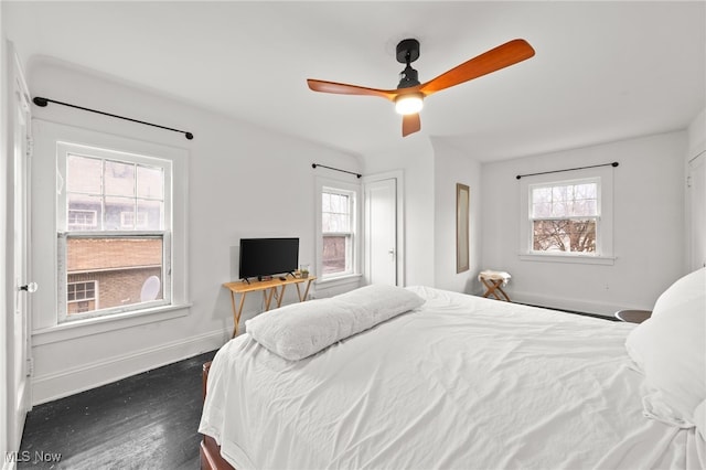 bedroom featuring ceiling fan and multiple windows