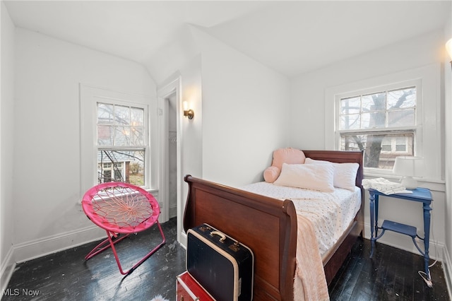 bedroom with dark hardwood / wood-style flooring and lofted ceiling