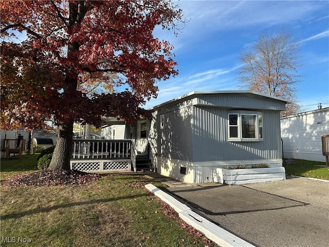 view of side of home featuring a lawn