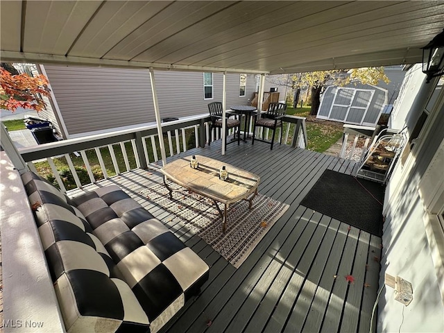 wooden deck with a storage shed