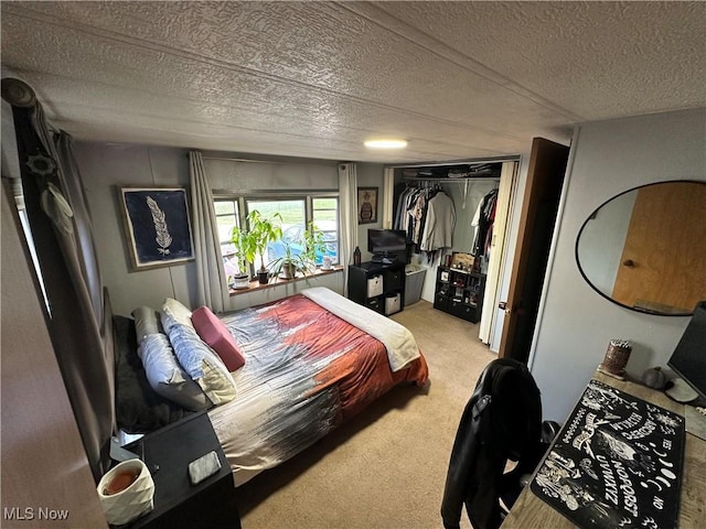 carpeted bedroom featuring a closet and a textured ceiling