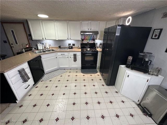 kitchen featuring sink, white cabinets, black appliances, and a textured ceiling