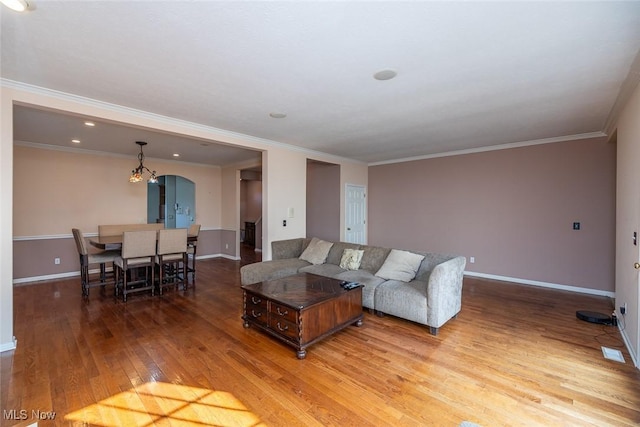 living room with hardwood / wood-style flooring and ornamental molding