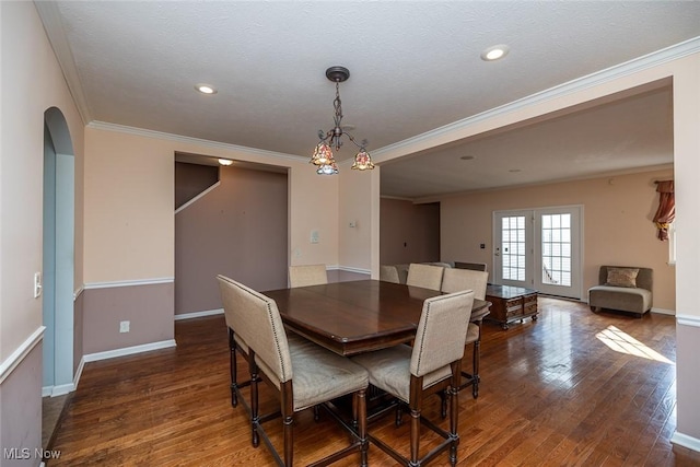 dining area with crown molding, a textured ceiling, and dark hardwood / wood-style flooring