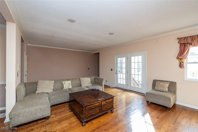 living room featuring ornamental molding and light wood-type flooring