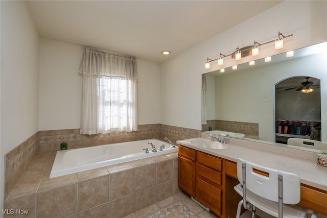 bathroom featuring vanity, tiled bath, tile patterned floors, and ceiling fan