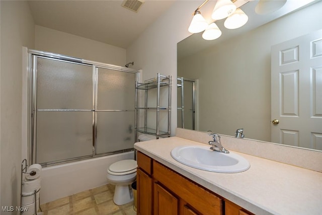 full bathroom with enclosed tub / shower combo, vanity, toilet, and a chandelier