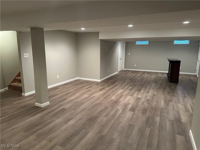 basement with dark hardwood / wood-style floors