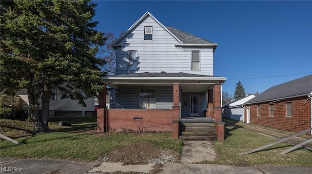 view of front facade featuring covered porch and a front lawn