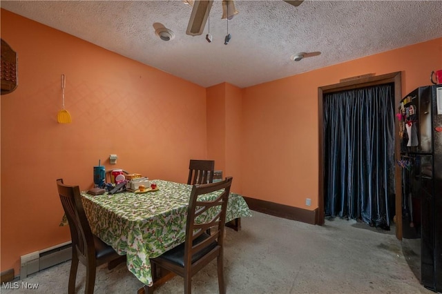 dining area featuring baseboard heating and a textured ceiling