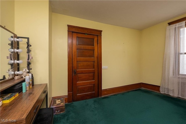 empty room featuring dark colored carpet