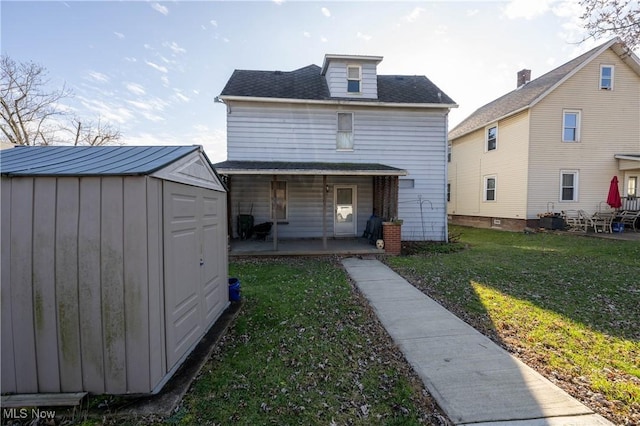 back of property with a lawn and a storage shed