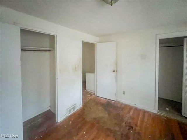 unfurnished bedroom featuring dark hardwood / wood-style flooring