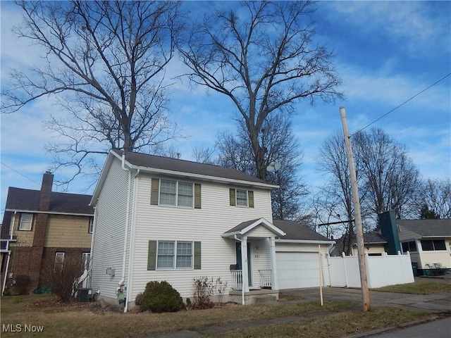 view of front of home featuring a garage and cooling unit