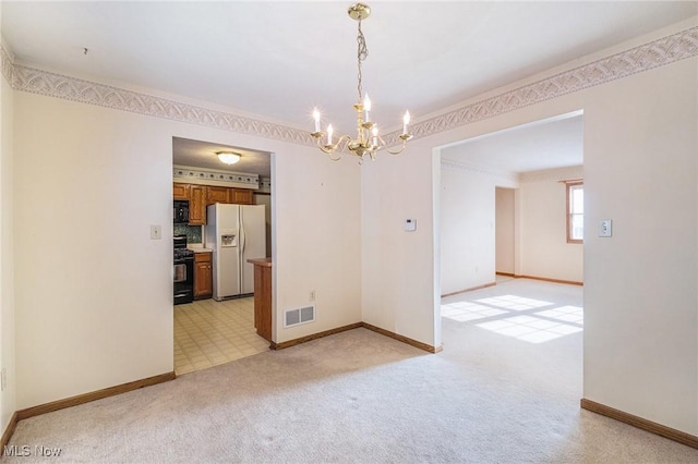 unfurnished dining area with light colored carpet, ornamental molding, and a notable chandelier