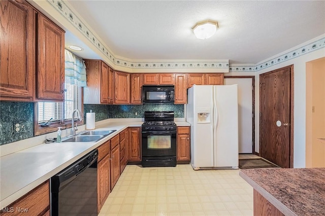 kitchen with sink, black appliances, and tasteful backsplash