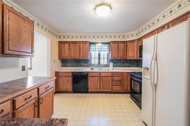 kitchen featuring black appliances, decorative backsplash, and sink