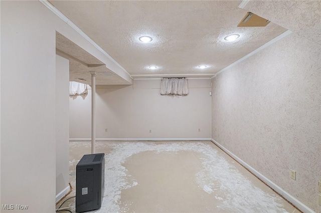 basement with a textured ceiling and ornamental molding