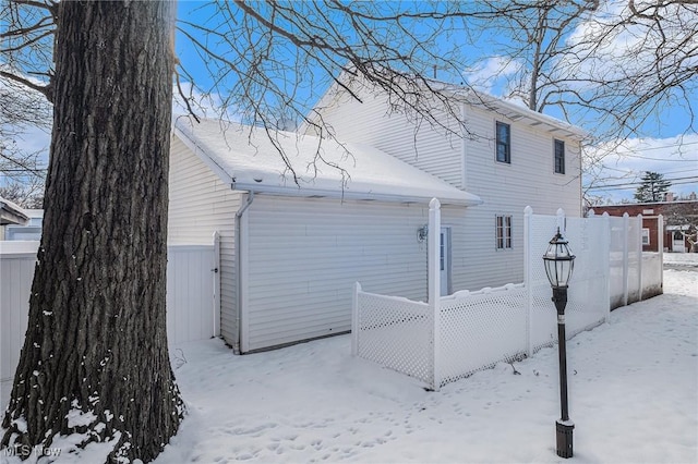 view of snow covered back of property