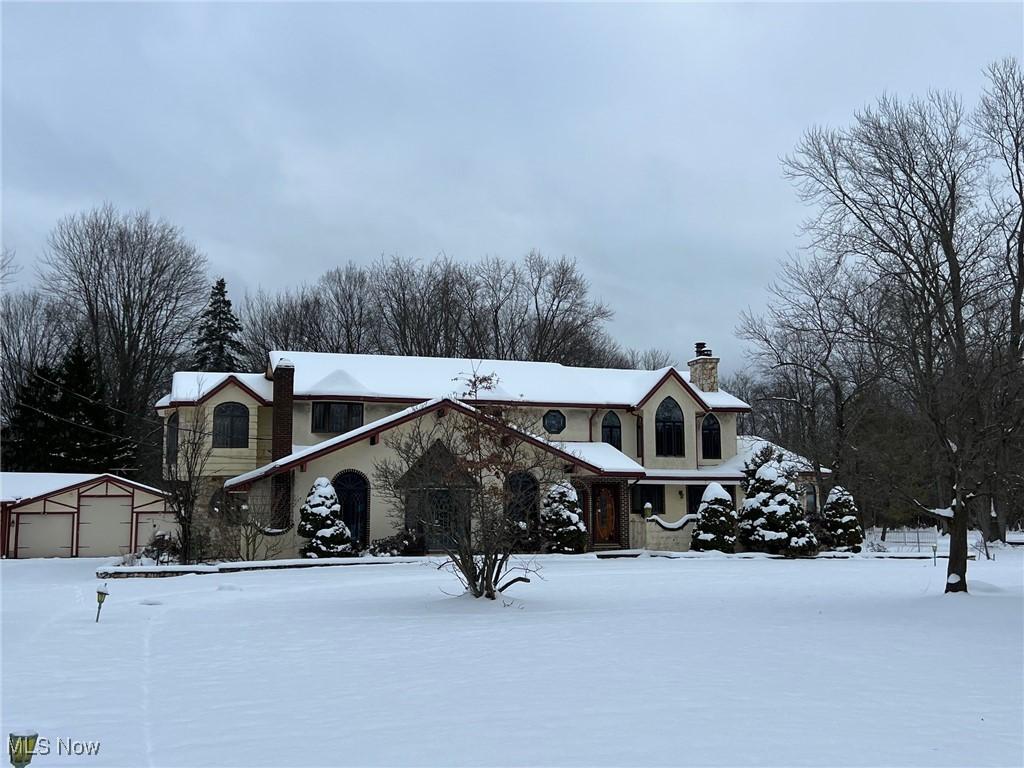 view of front of property featuring a garage and an outdoor structure