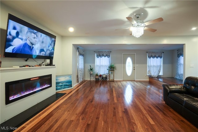 living room featuring hardwood / wood-style floors and ceiling fan